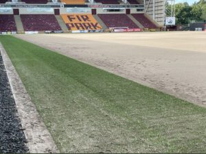 The first band of stitched playing surface, 95% natural grass